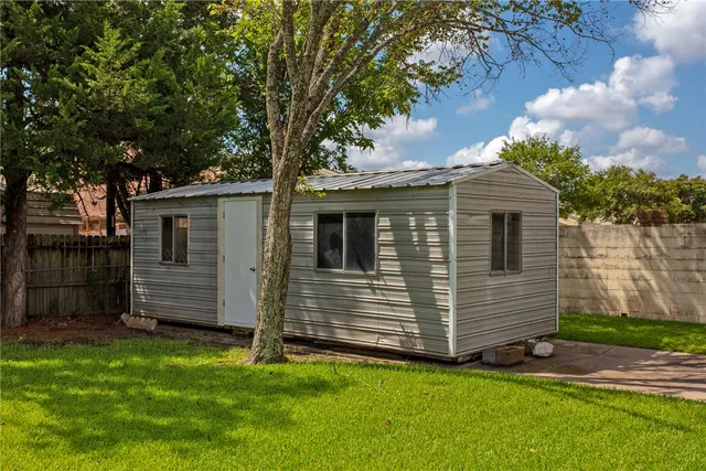 a kitchen with sink a window and cabinets