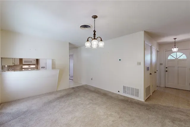 a view of an empty room with a kitchen