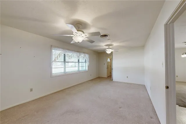 a kitchen with white cabinets and chandelier