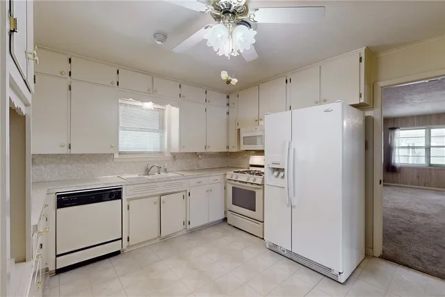 a kitchen with cabinets and appliances