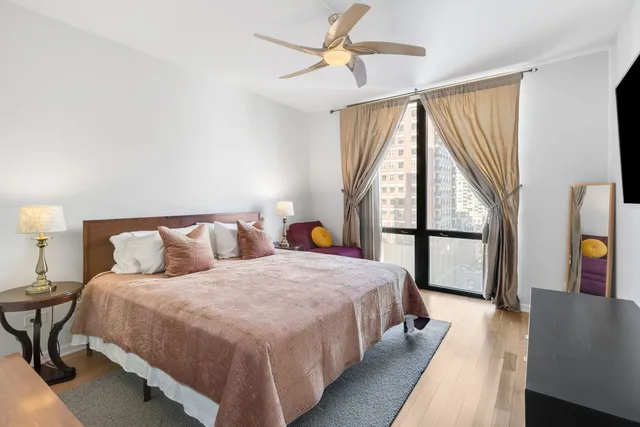 a bedroom with a large bed and a large window