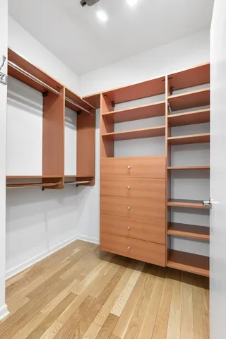 a view of walk in closet with empty racks