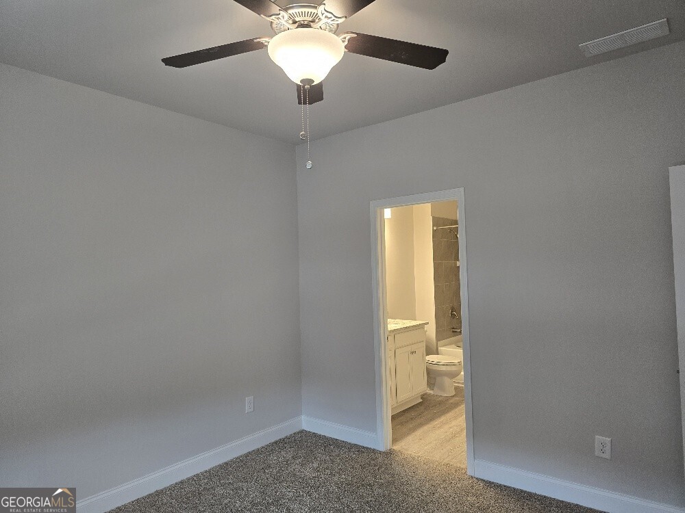 3405 Ripple Loop, Unit 127 Atlanta, GA 30349 - Photo 18 of 26 an empty room with a empty space and a ceiling fan
