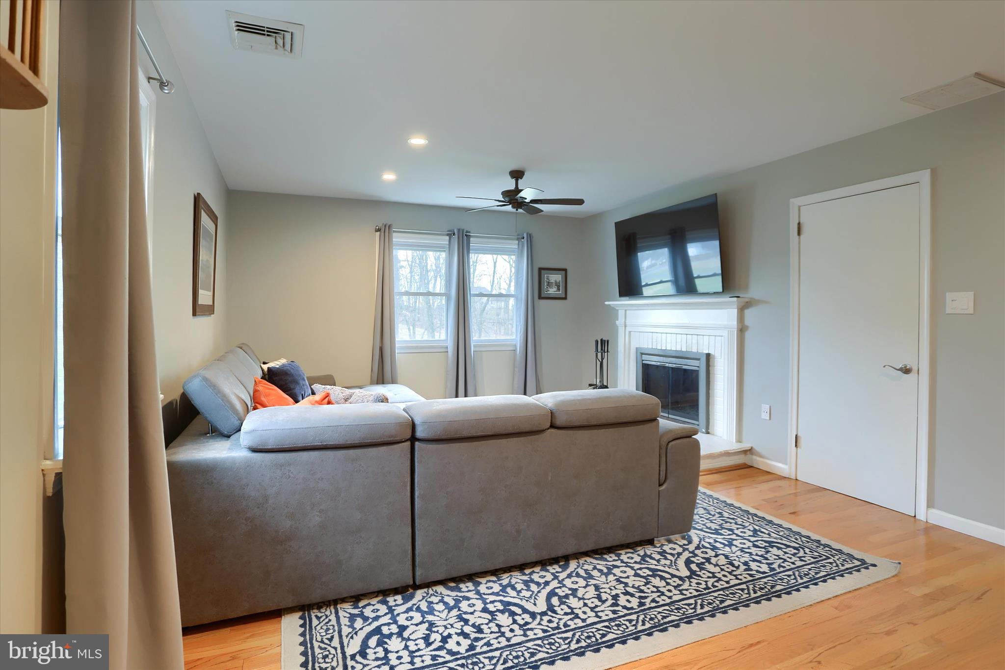1288 Copeland School Road West Chester, PA 19380 - Photo 11 of 36 a living room with furniture a flat screen tv and a fireplace
