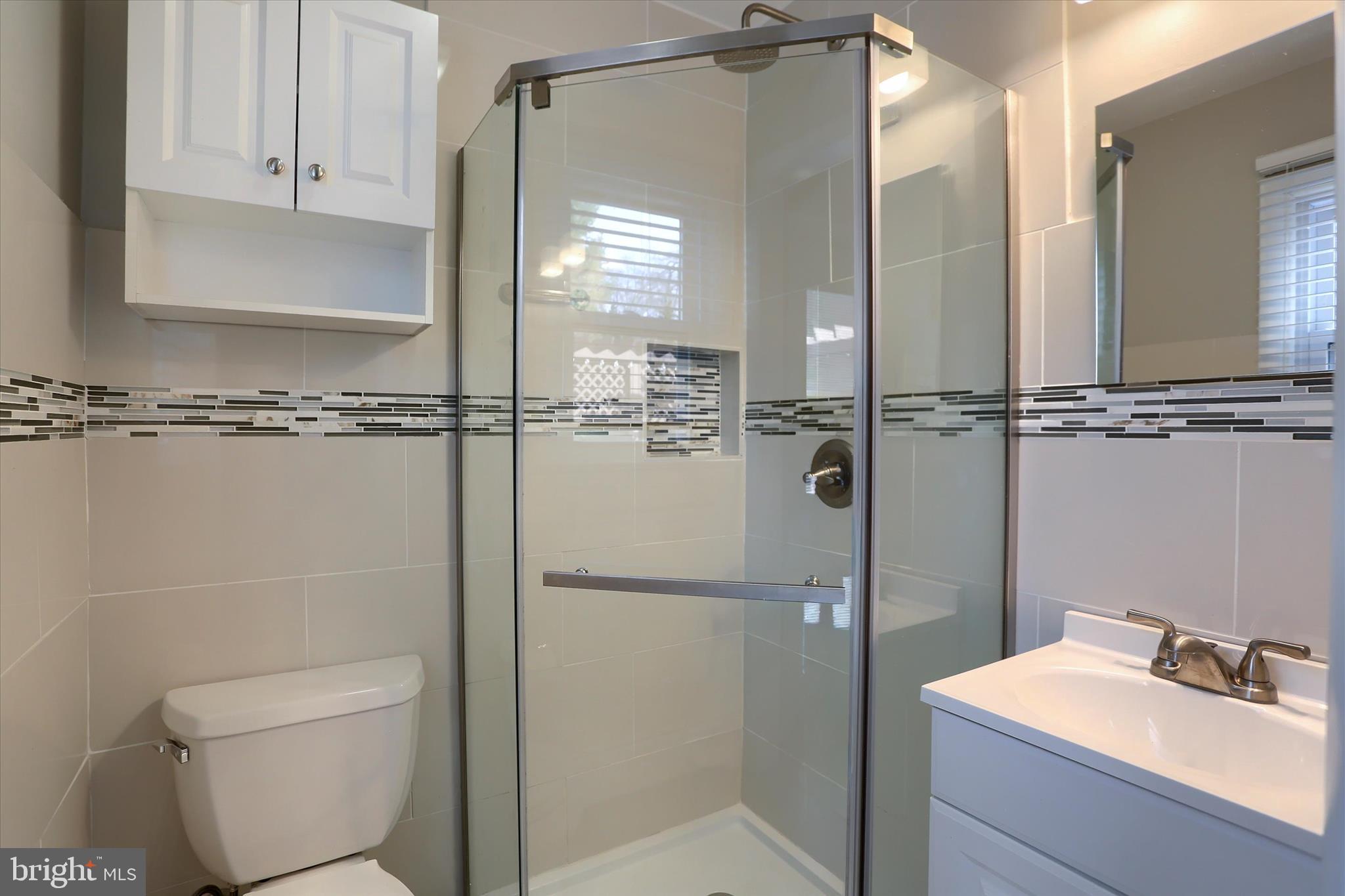 1288 Copeland School Road West Chester, PA 19380 - Photo 20 of 36 a bathroom with a shower a mirror and a sink