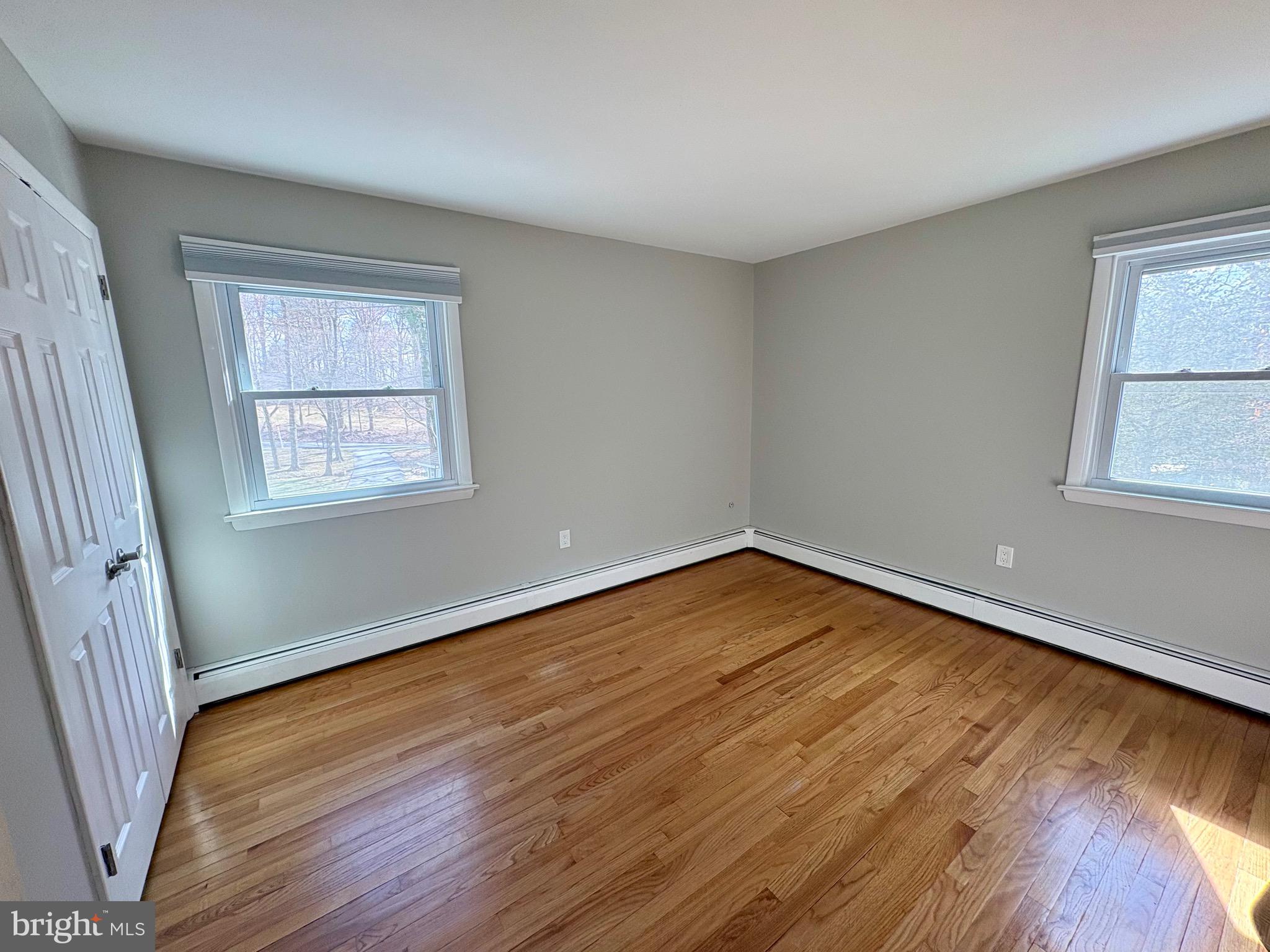 1288 Copeland School Road West Chester, PA 19380 - Photo 21 of 36 a view of an empty room with wooden floor and a window