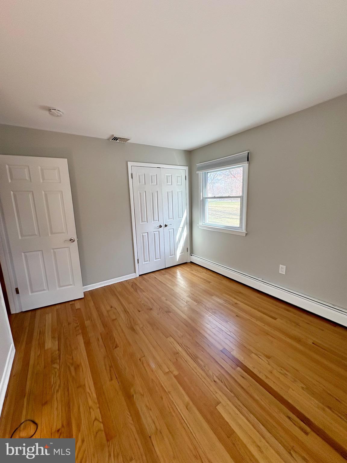 1288 Copeland School Road West Chester, PA 19380 - Photo 22 of 36 a view of empty room with wooden floor and fan