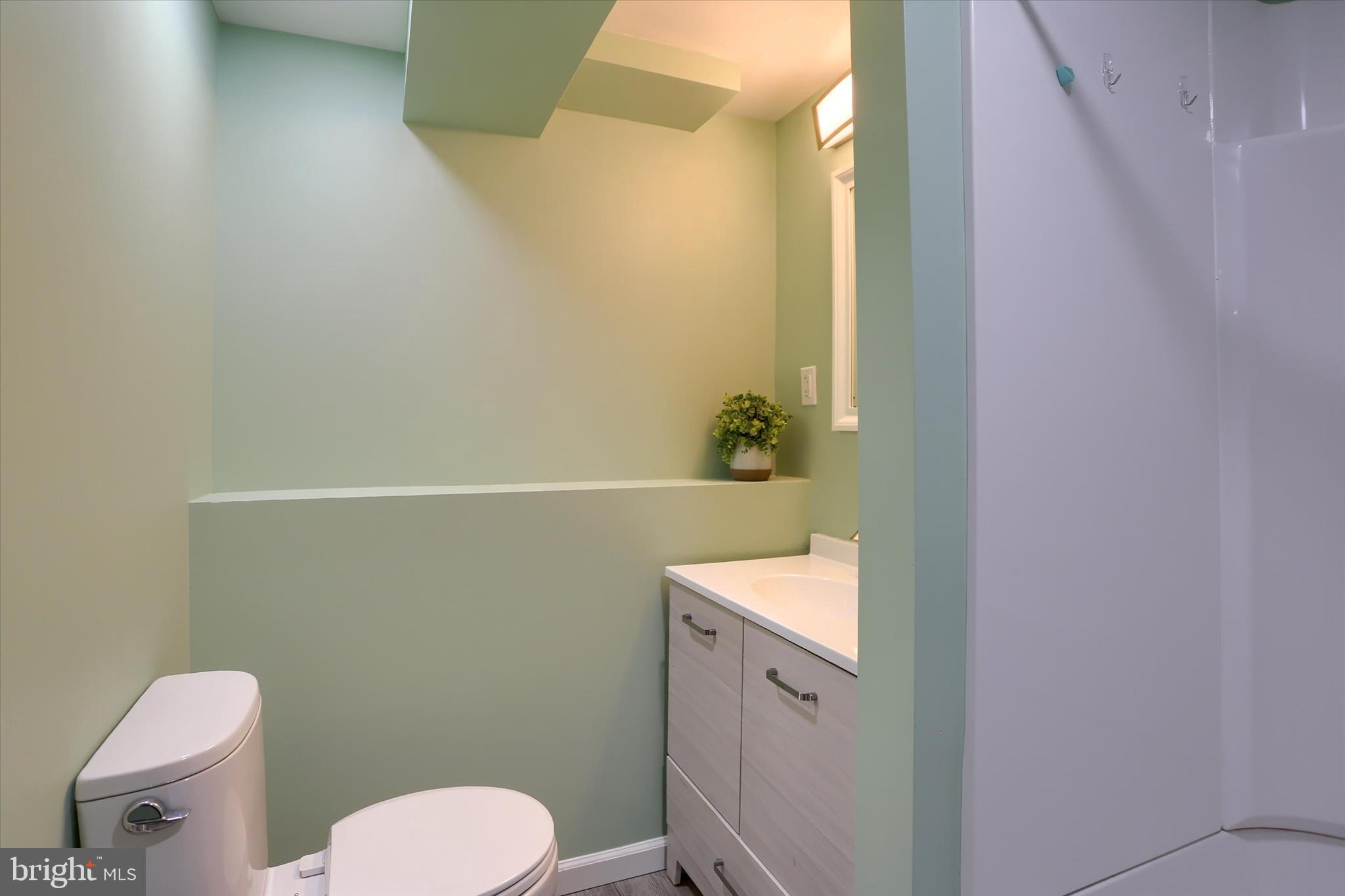 1288 Copeland School Road West Chester, PA 19380 - Photo 29 of 36 a bathroom with a sink a toilet and a mirror