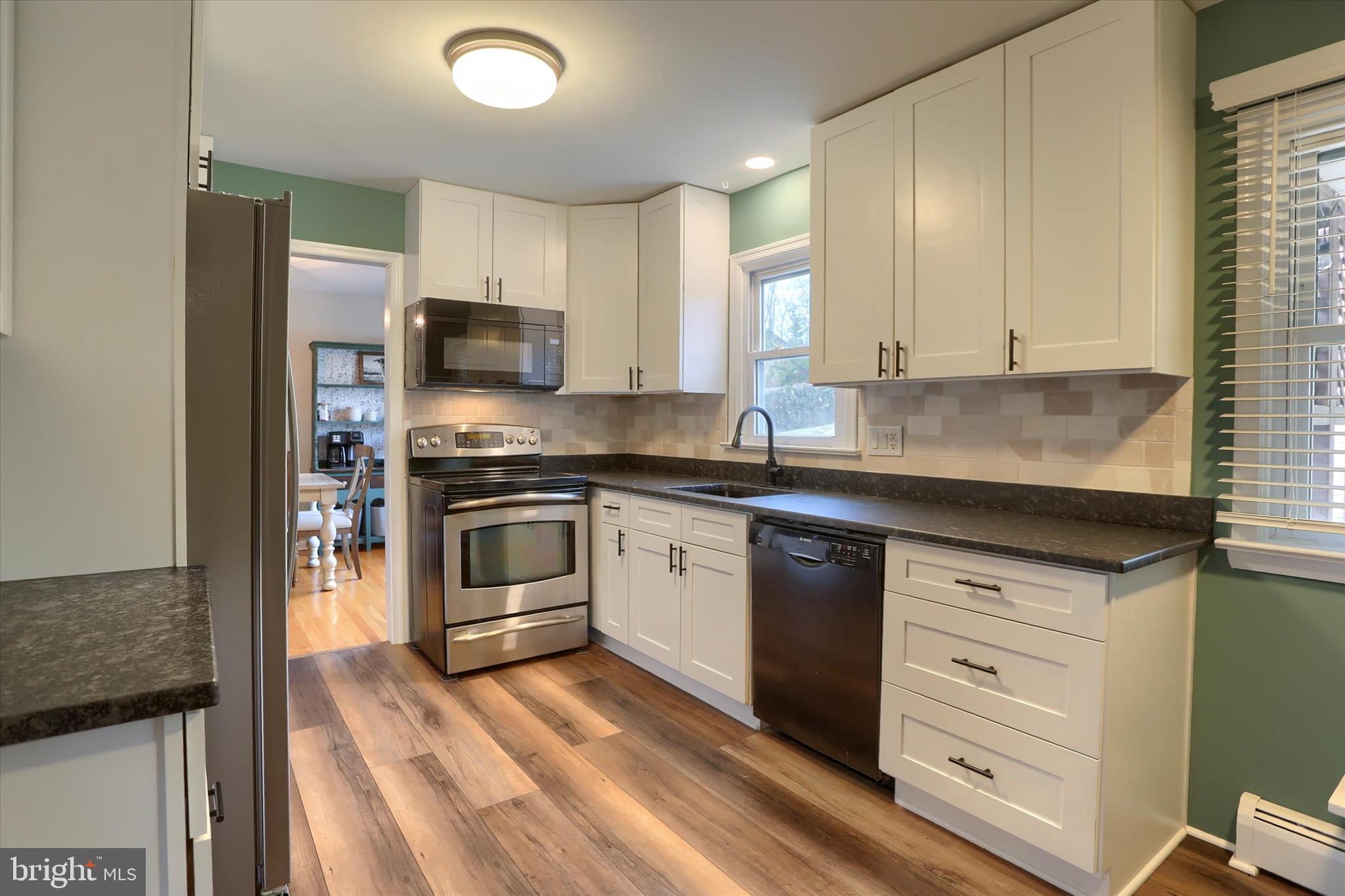 1288 Copeland School Road West Chester, PA 19380 - Photo 8 of 36 a kitchen with granite countertop a stove and a sink