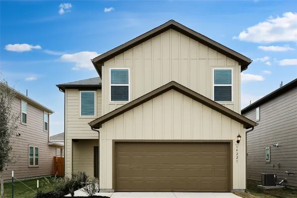 a front view of a house with garage