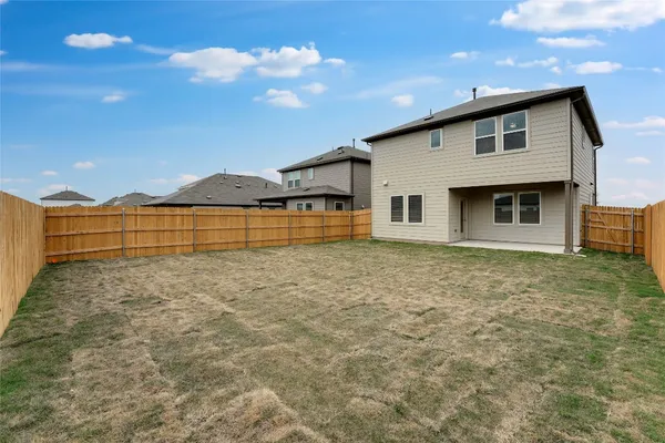 a view of a house with backyard