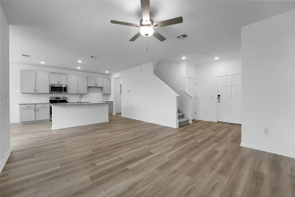 a view of a kitchen with a stove cabinets and wooden floor