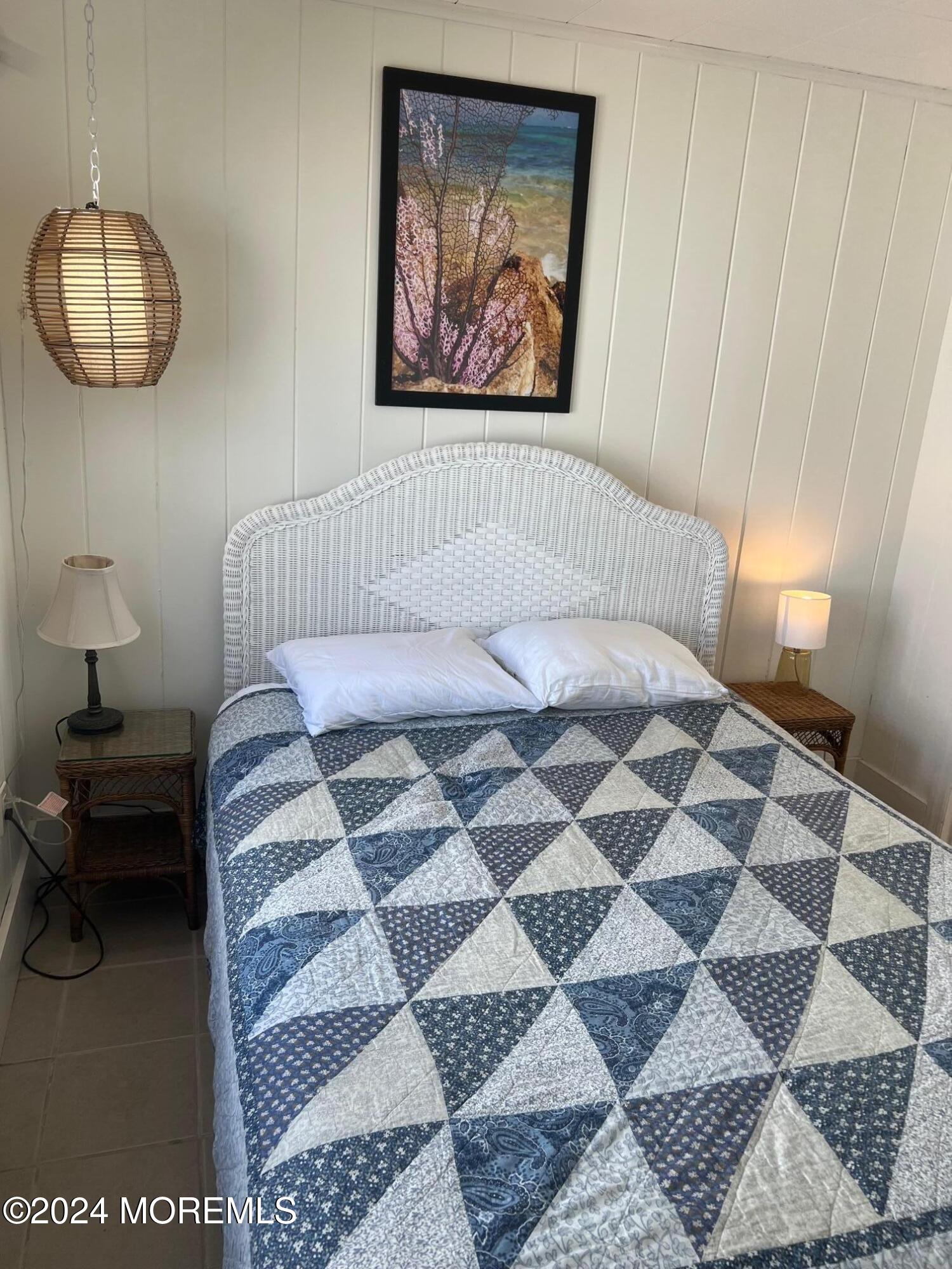 3164 Ocean Road Lavallette, NJ 08735 - Photo 12 of 14 a bedroom with a bed and a painting on the wall