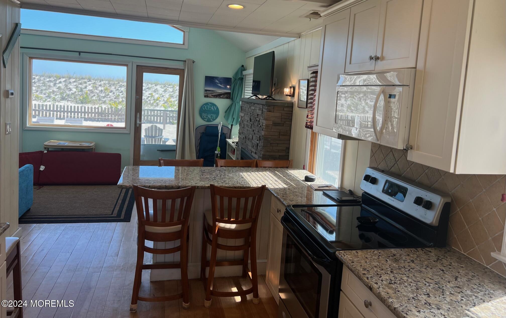3164 Ocean Road Lavallette, NJ 08735 - Photo 8 of 14 a kitchen with stainless steel appliances granite countertop a stove a sink dishwasher and a refrigerator