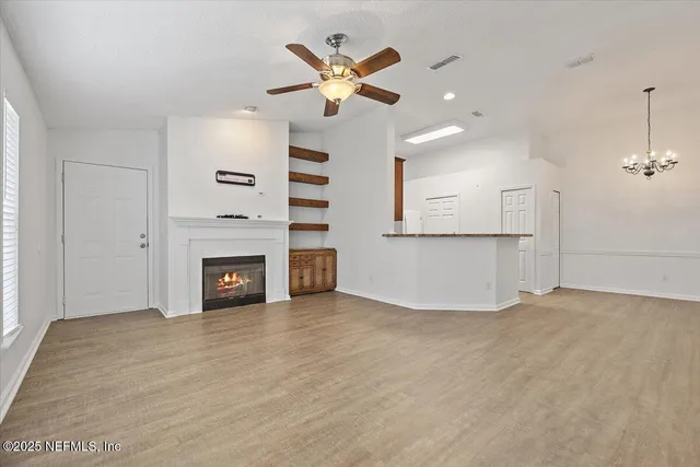 an empty room with fireplace and windows