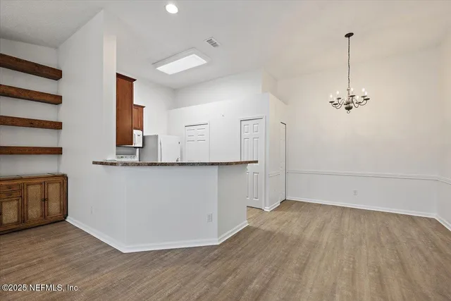 a view of a kitchen with wooden floor and a sink