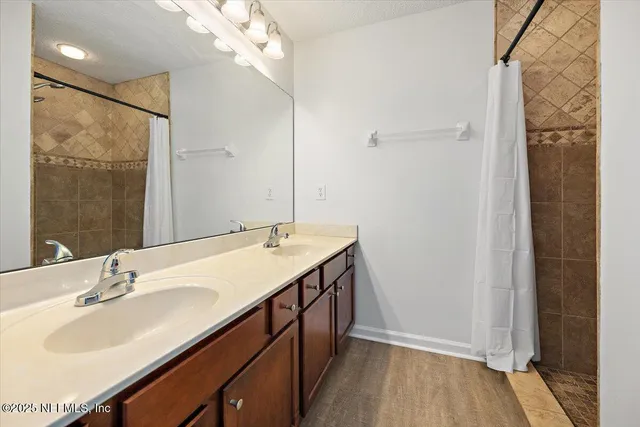 a bathroom with a sink double vanity and a mirror