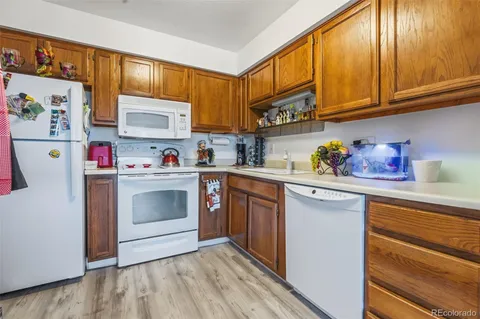 a kitchen with stainless steel appliances granite countertop a refrigerator sink and cabinets