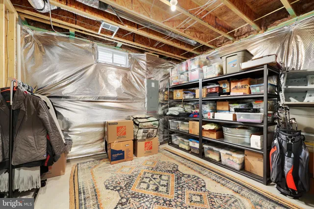 a porch with a chair and potted plant