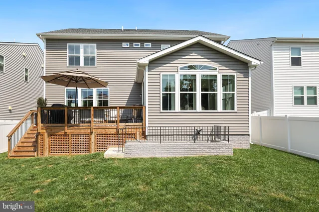 a view of yard with swimming pool and trees in the background