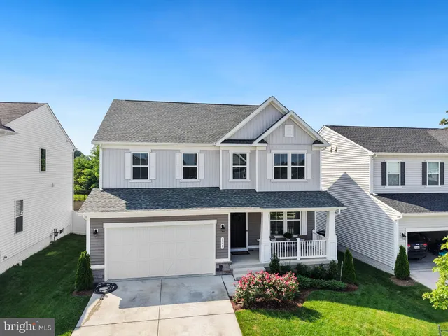 an aerial view of residential houses with outdoor space and swimming pool
