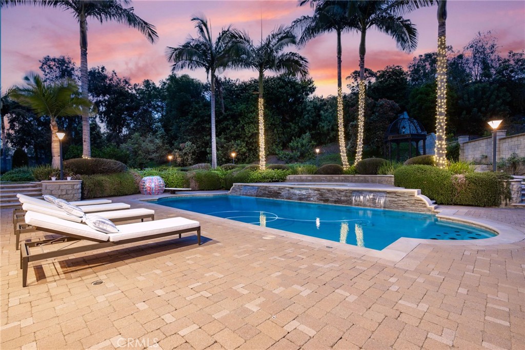 a view of a backyard with a patio and palm trees