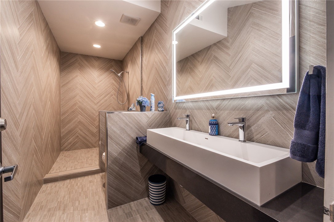 10372 South Crawford Canyon Road Santa Ana, CA 92705 - Photo 19 of 75 a bathroom with a sink and a mirror