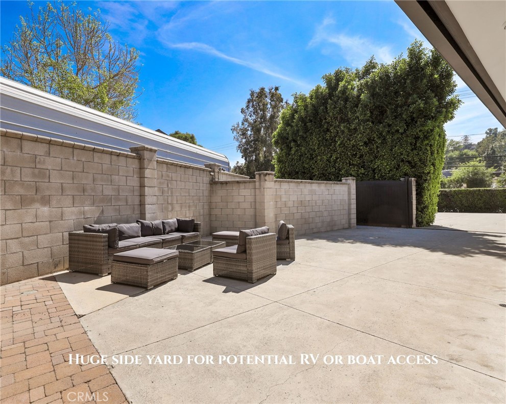 10372 South Crawford Canyon Road Santa Ana, CA 92705 - Photo 23 of 75 a backyard of a house with barbeque oven and outdoor seating