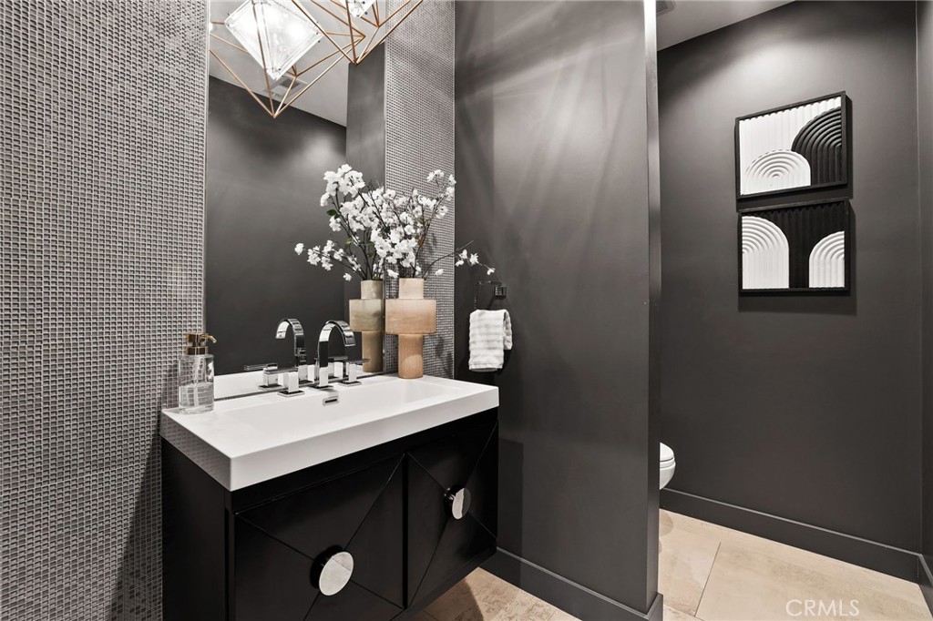 10372 South Crawford Canyon Road Santa Ana, CA 92705 - Photo 38 of 75 a bathroom with a sink vanity and a mirror