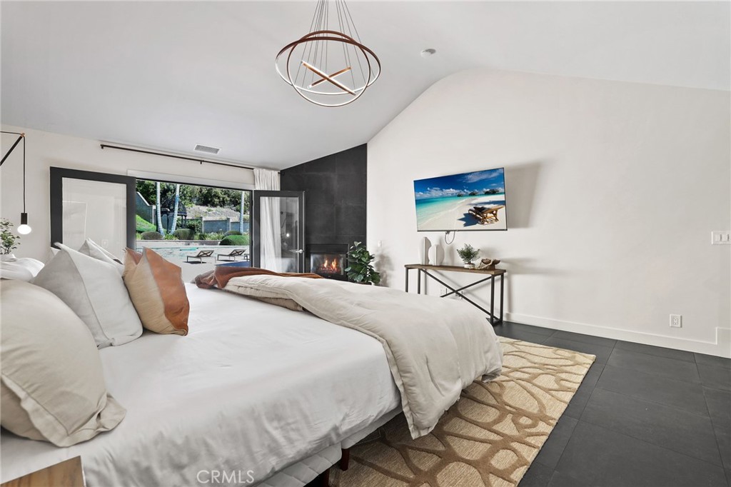 10372 South Crawford Canyon Road Santa Ana, CA 92705 - Photo 40 of 75 a bedroom with a large bed and a large window