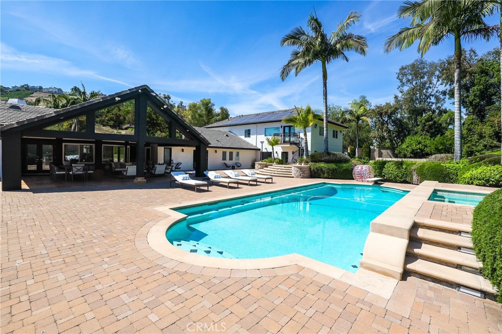 10372 South Crawford Canyon Road Santa Ana, CA 92705 - Photo 4 of 75 a view of swimming pool with outdoor seating and a garden