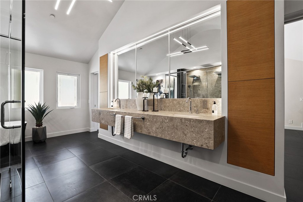 10372 South Crawford Canyon Road Santa Ana, CA 92705 - Photo 42 of 75 a bathroom with a tub a sink and a mirror