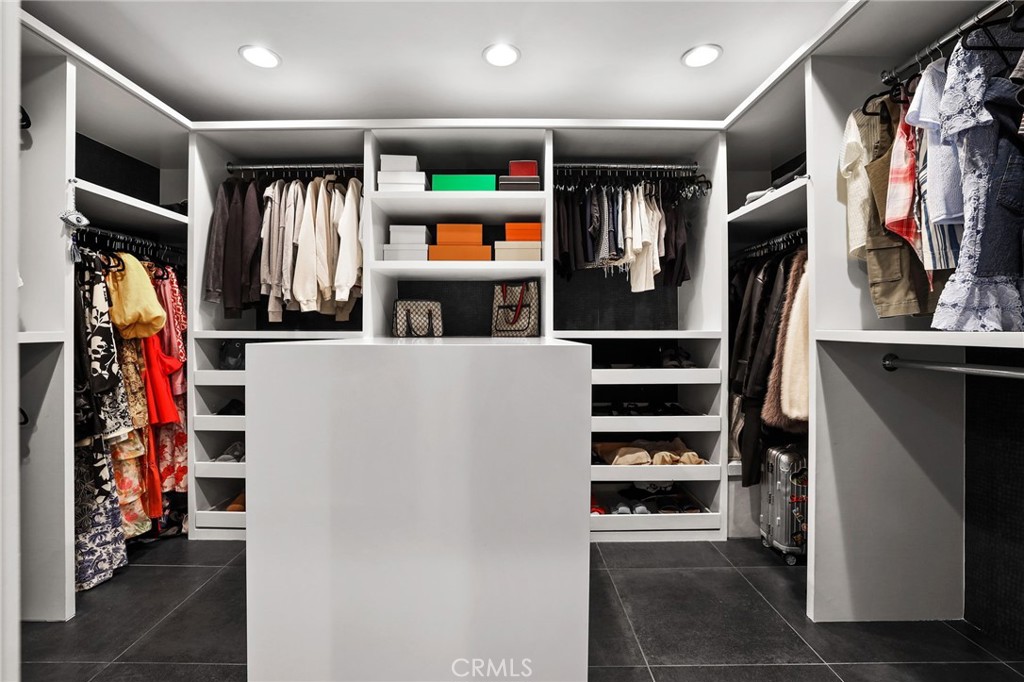 10372 South Crawford Canyon Road Santa Ana, CA 92705 - Photo 44 of 75 a view of walk in closet with clothes and shoes