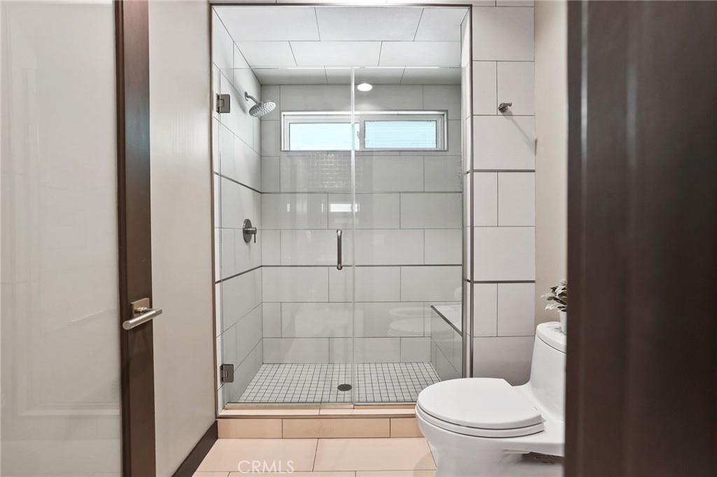 10372 South Crawford Canyon Road Santa Ana, CA 92705 - Photo 52 of 75 a bathroom with a toilet and a shower