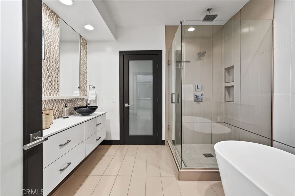 10372 South Crawford Canyon Road Santa Ana, CA 92705 - Photo 57 of 75 a bathroom with a double vanity sink toilet and shower