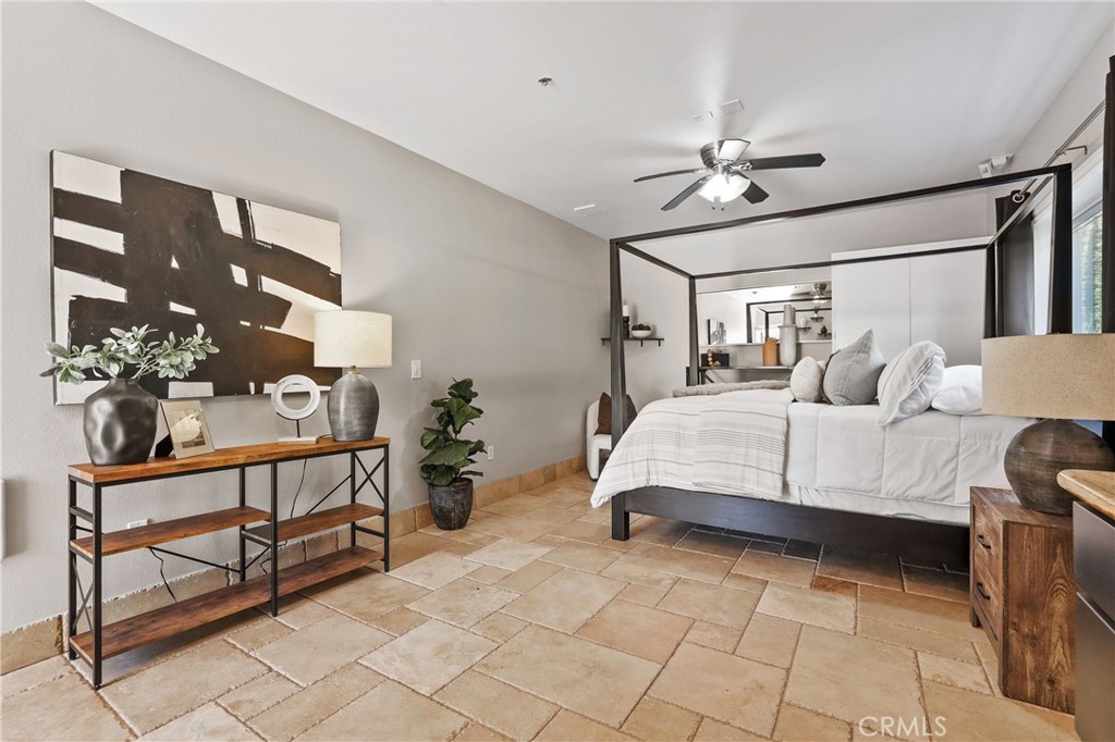 10372 South Crawford Canyon Road Santa Ana, CA 92705 - Photo 60 of 75 a bedroom with a bed and a chandelier