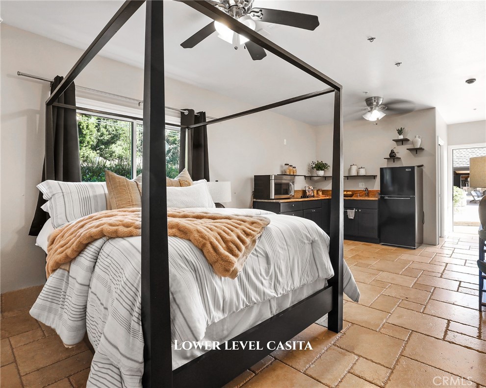 10372 South Crawford Canyon Road Santa Ana, CA 92705 - Photo 61 of 75 a bedroom with a bed and wooden floor