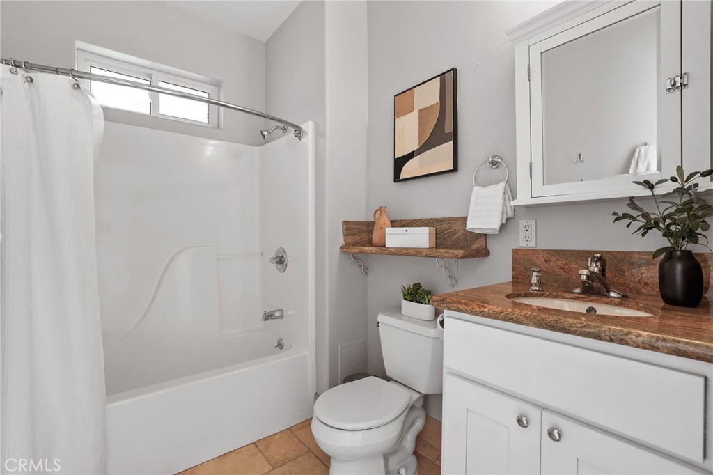 10372 South Crawford Canyon Road Santa Ana, CA 92705 - Photo 62 of 75 a bathroom with a granite countertop sink toilet and shower