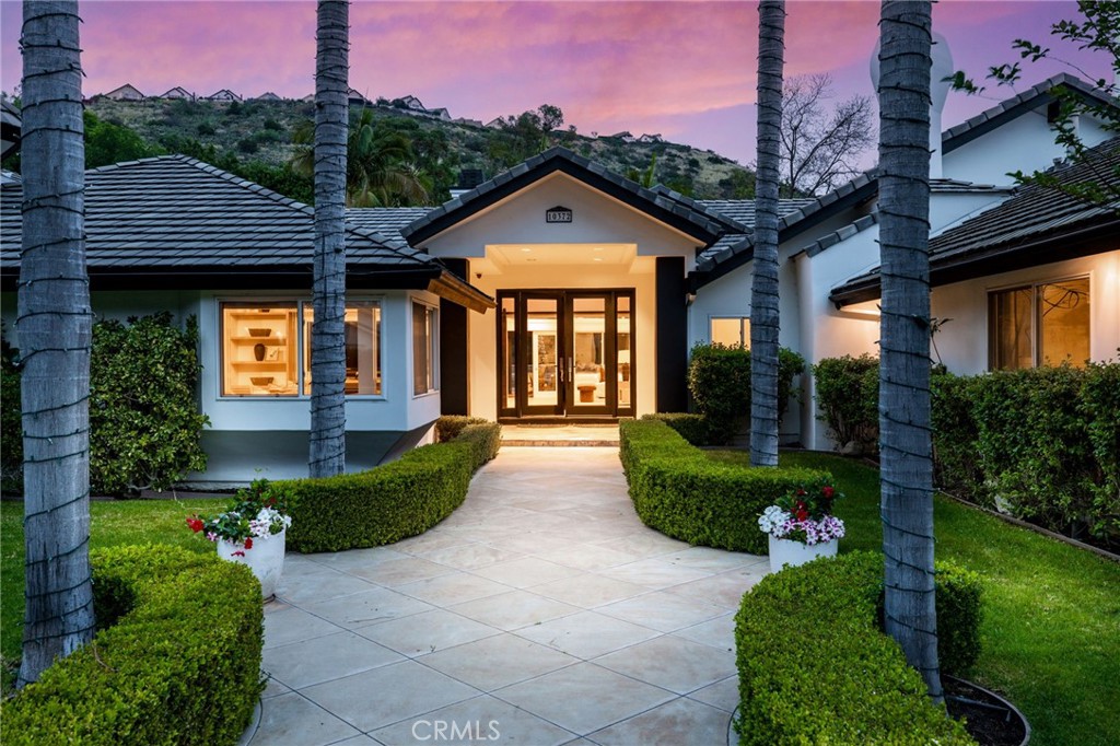 10372 South Crawford Canyon Road Santa Ana, CA 92705 - Photo 70 of 75 a front view of a house with a yard and potted plants
