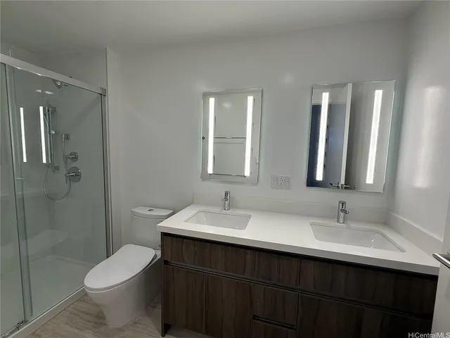 a bathroom with a sink toilet and shower