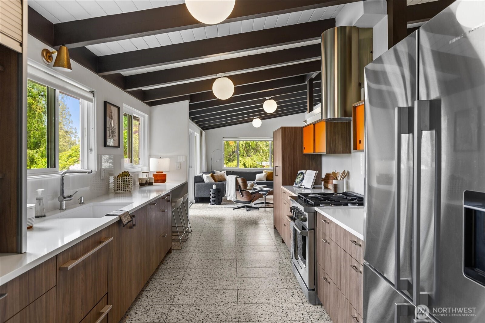 18722 84th Avenue West Edmonds, WA 98026 - Photo 11 of 40 a kitchen with stainless steel appliances a stove a sink a refrigerator cabinets and a dining table