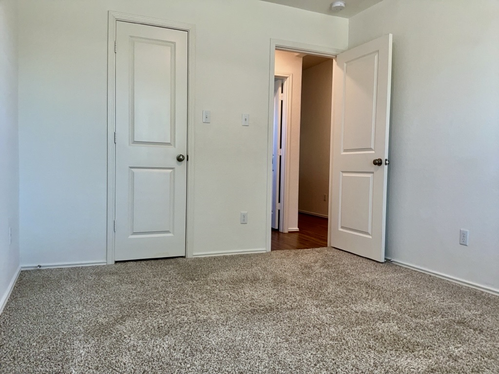 101 COSMOS Lane, Unit 32K Jarrell, TX 76537 - Photo 18 of 20 Bedroom with baseboards and carpet floors