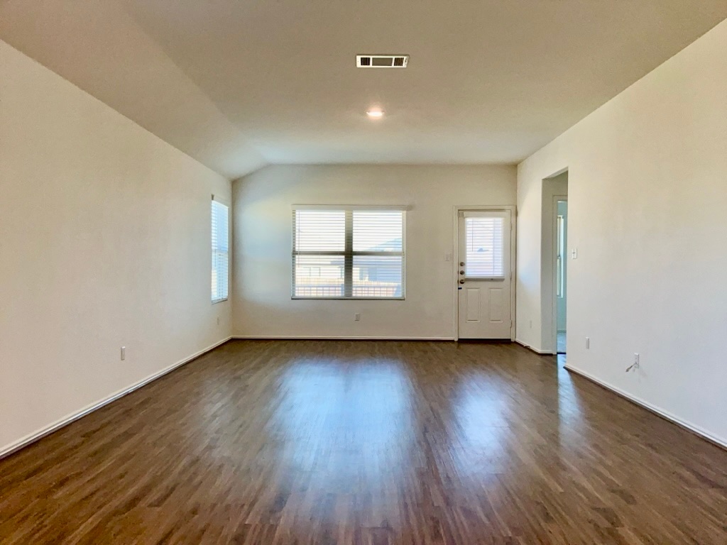 101 COSMOS Lane, Unit 32K Jarrell, TX 76537 - Photo 2 of 20 Living room featuring dark wood-style floors and baseboards