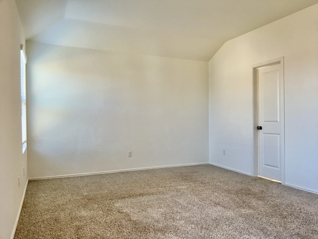 101 COSMOS Lane, Unit 32K Jarrell, TX 76537 - Photo 8 of 20 Bedroom with carpet and lofted ceiling