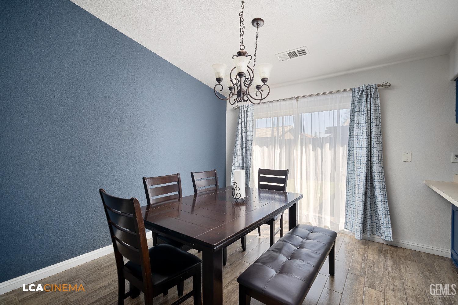 Undisclosed Address McFarland, CA 93250 - Photo 13 of 24 a view of a dining room with furniture window and wooden floor