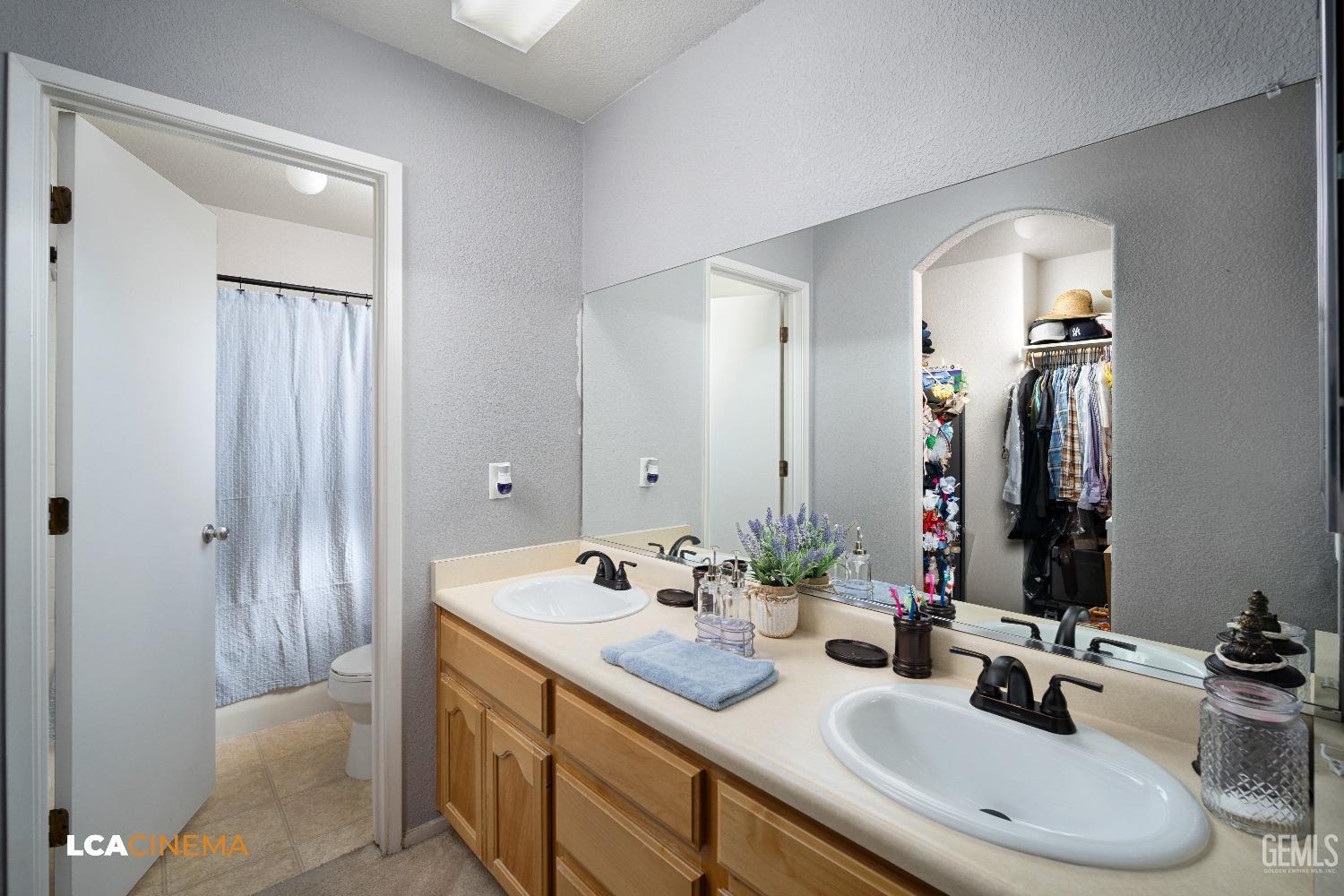 Undisclosed Address McFarland, CA 93250 - Photo 16 of 24 a bathroom with a double vanity sink and a mirror