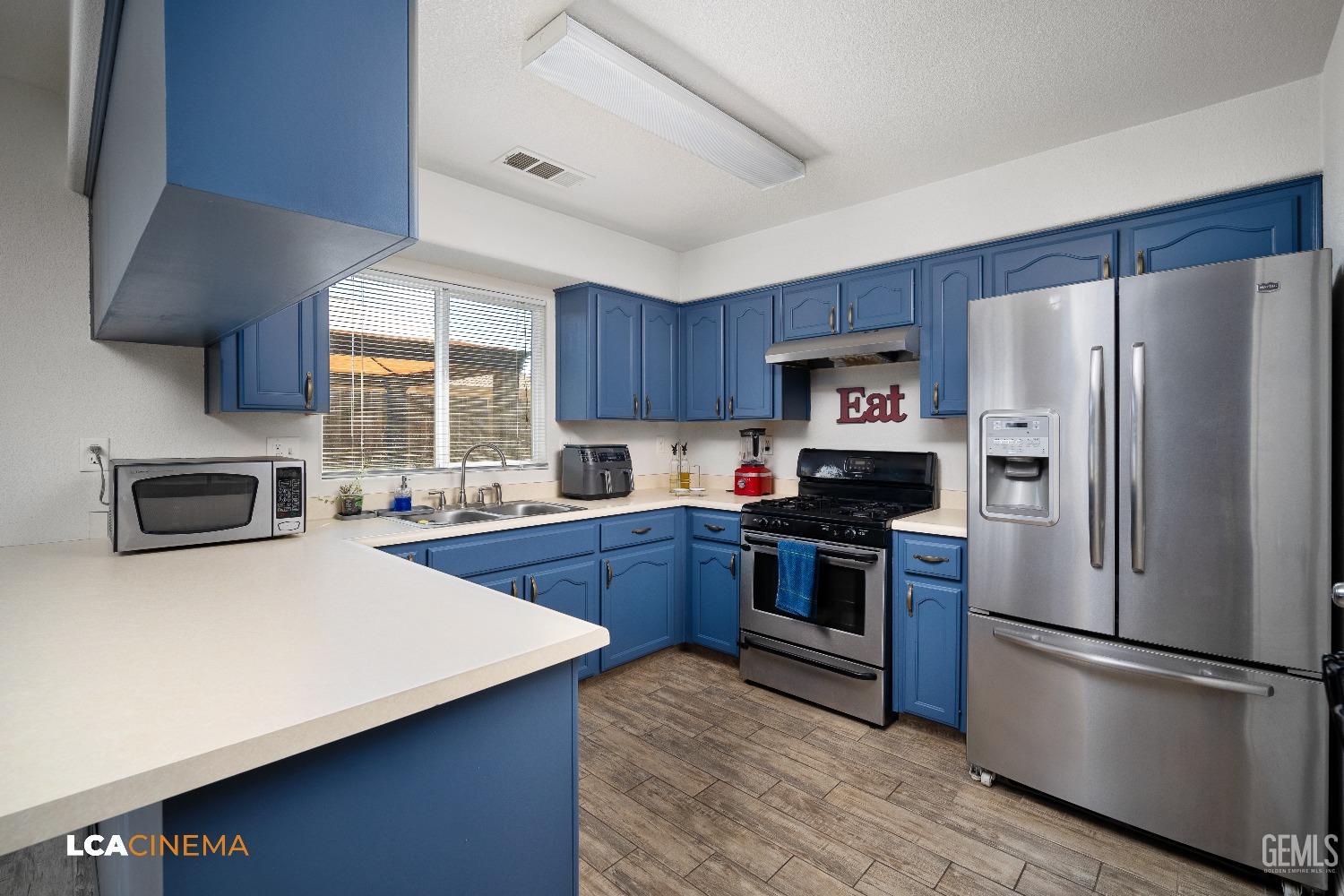 Undisclosed Address McFarland, CA 93250 - Photo 10 of 24 a kitchen with stainless steel appliances a refrigerator a stove a sink and a oven