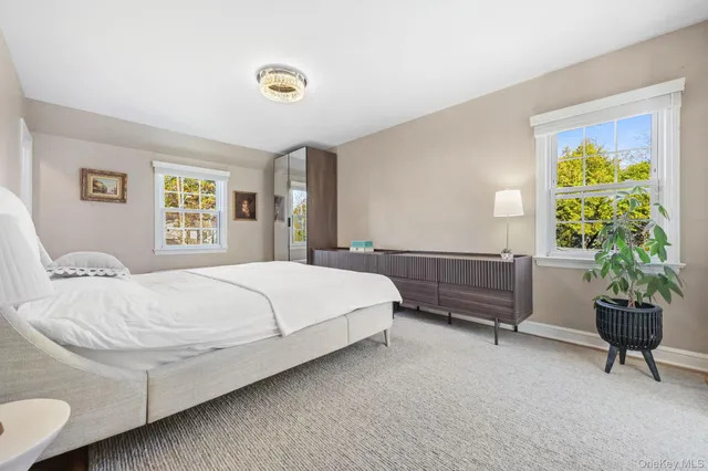 a bedroom with a bed and a chair