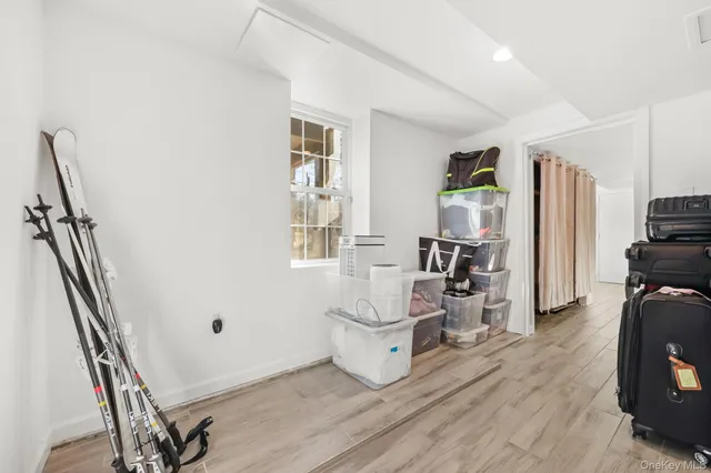 a view of a workspace with furniture and wooden floor