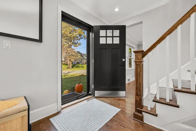 a view of a hallway with wooden floor and windows
